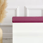 Eine große Korbvase mit Pampasgras steht neben einer weißen Bank mit der KraftKids GmbH Sitzauflage für Ikea TROFAST Leinen magenta dunkel, vor einer weißen Wand mit Zierleiste.