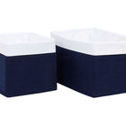 Zwei KraftKids Körbchen Musselin dunkelblau - mit weißem Rand, eines etwas kleiner - stehen nebeneinander auf weißem Grund. Diese stilvollen Stofforganisatoren sind ideal für die Aufbewahrung im Kinderzimmer.